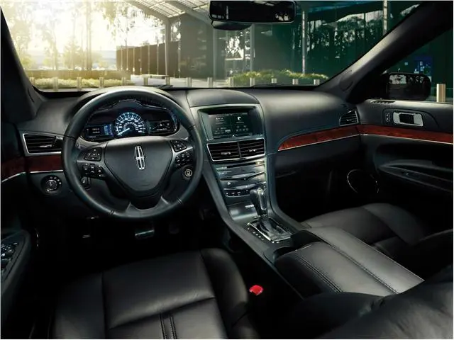 Luxury car interior with sleek dashboard and black leather seats.